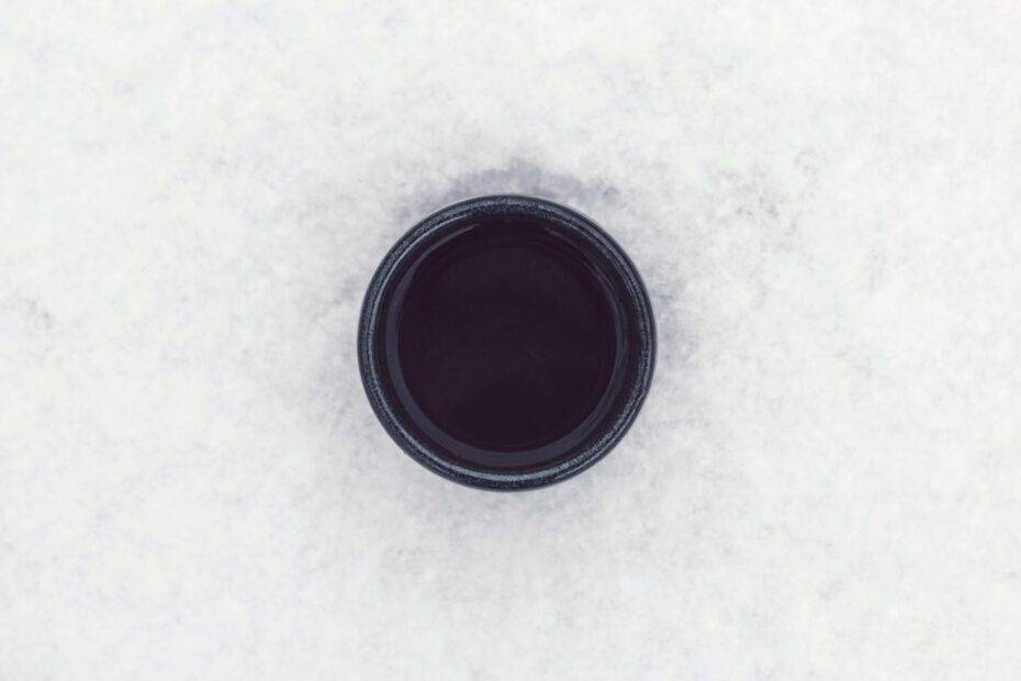 round black container on top of white surface
