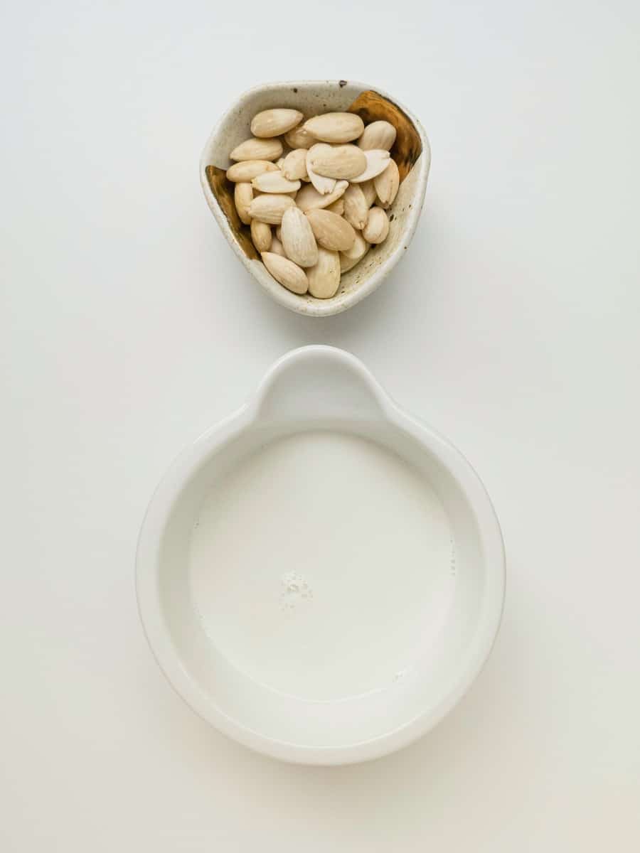 flat lay photography of an empty bowl and a bowl of white seeds
