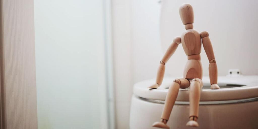 toilet with a stick figurine