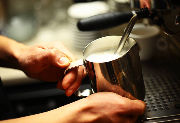 a bartender italian restaurant preparing coffee steam milk cappuccino preparation people barista cafeteria