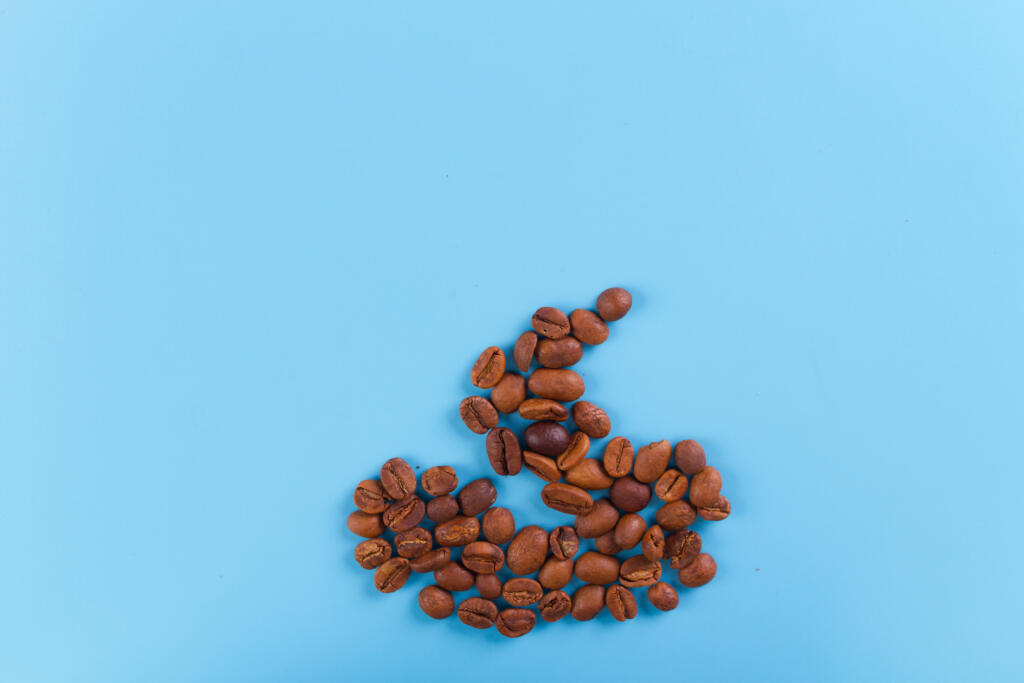 coffee beans in a shape of shit. blue background