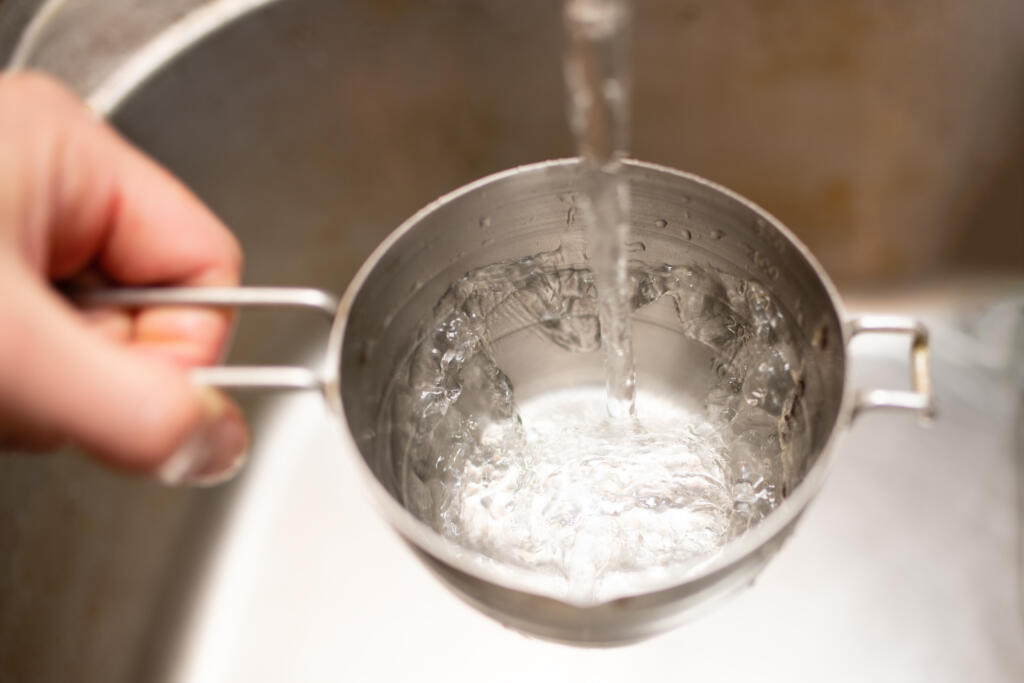 Pour water into measuring cup