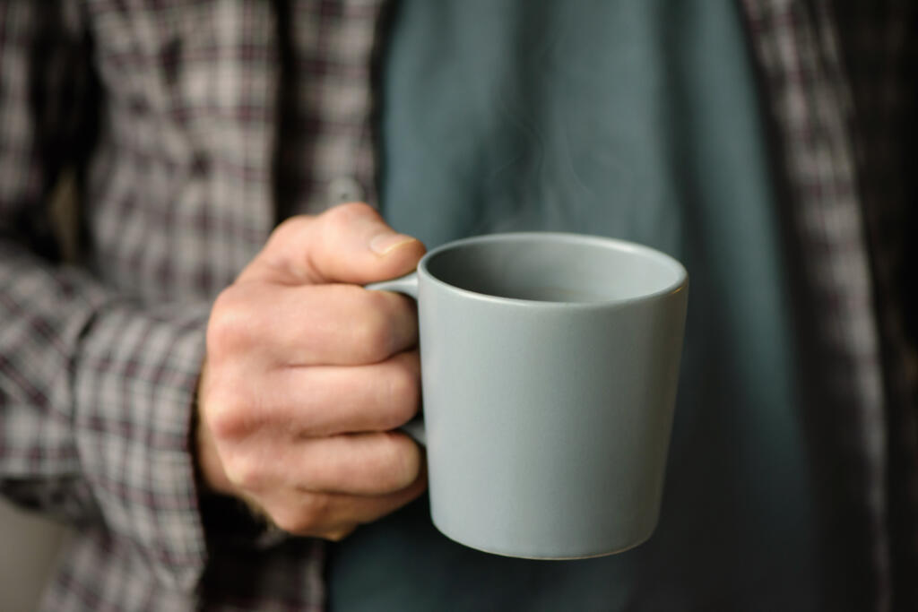 Cup of coffee in a man's hand